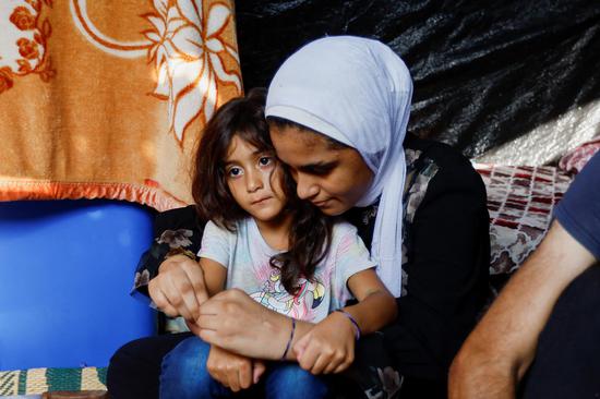 Palestinians in Gaza wear ID bracelets for identification